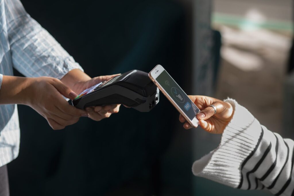 person-paying-with-nfc-technology-restaurant-min-scaled.jpg